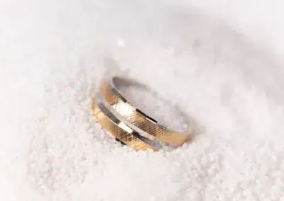 A 14 Karat Yellow Gold Fashion Chain sitting on top of snow.