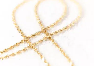 Two 14 Karat Yellow Gold Fashion Chain necklaces on a white surface.