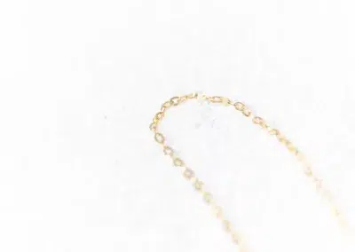 A small 14 Karat Yellow Gold Fashion Chain necklace on a white surface.