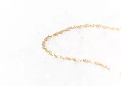 A 14 Karat Yellow Gold Fashion Chain made of yellow gold, gleaming on a white surface.