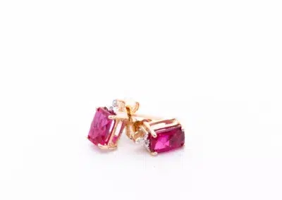 14 Karat yellow gold ruby and diamond stud earrings.