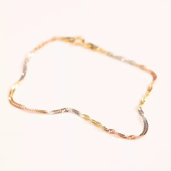 A twisted tri-color 14 Karat Yellow Gold Figaro 25" Chain on a white background.