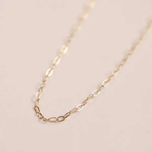 25" Figaro chain necklace in 14 Karat Yellow Gold on a pale pink background.
Product Name: 14 Karat Yellow Gold Figaro 25" Chain