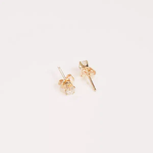 A pair of 14 Karat Yellow Gold Comfort Fit Band earrings with diamonds.