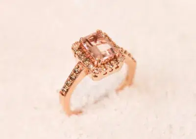 A rose gold ring with a morganite stone and a 14 Karat Yellow Gold Comfort Fit Band.