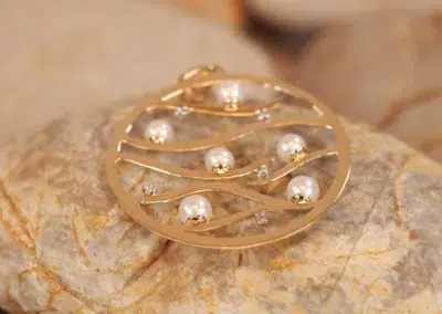 A 14 Karat Yellow Gold Comfort Fit Band with pearls and diamonds.