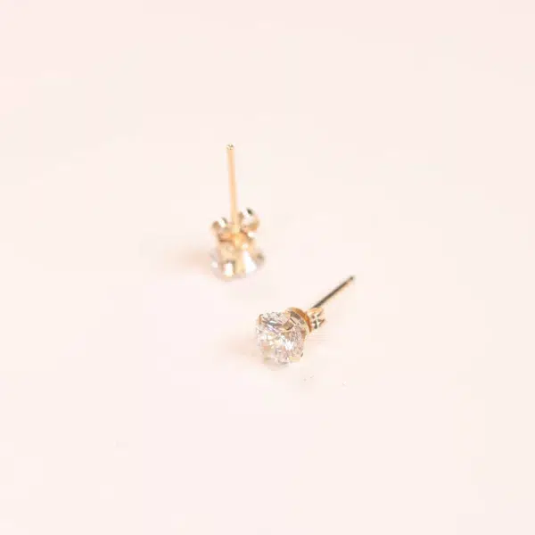 A pair of 14 Karat Yellow Gold Comfort Fit Band earrings with diamonds.