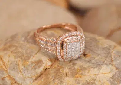 A rose gold ring with diamonds on top of rocks and a 14 Karat Yellow Gold Comfort Fit Band.