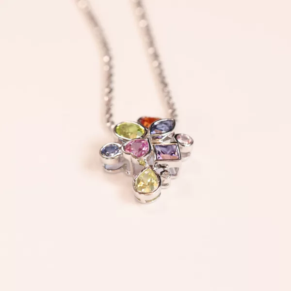 A necklace with multi-colored stones on it, set in 14 Karat Yellow Gold Comfort Fit Band.
