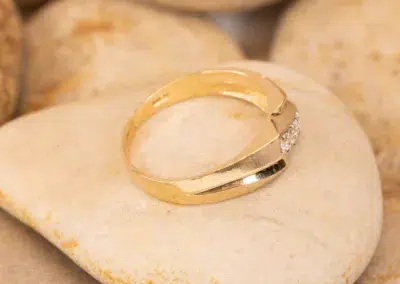 14K YG Diamonds & Peach Tourmaline Ring with a single diamond resting on a smooth, peach tourmaline stone.
