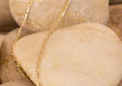 14K YG Diamonds & Peach Tourmaline Ring draped over smooth peach tourmaline stones.