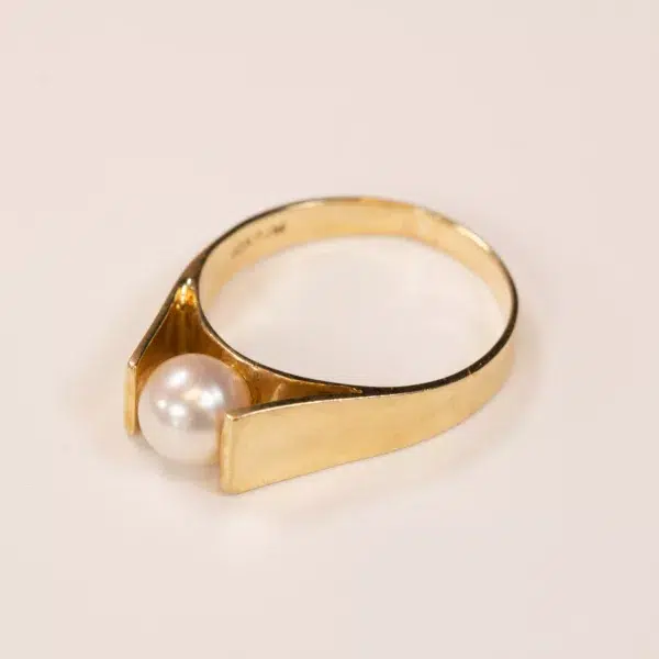 14K YG Diamonds & Peach Tourmaline Ring featuring a single peach tourmaline set on a plain band, displayed against a light neutral background.